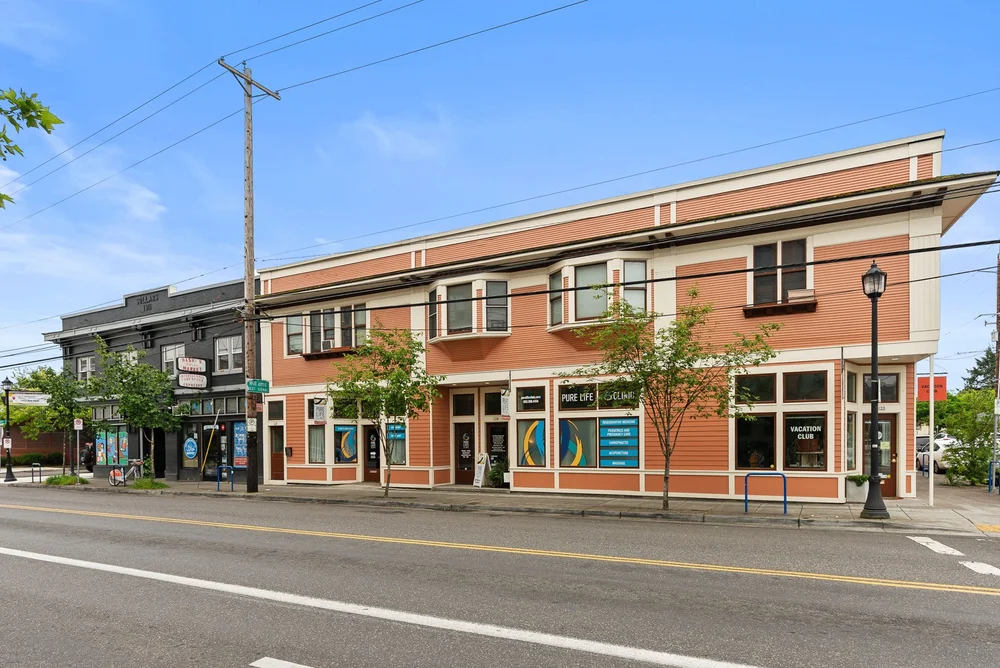 Two-story mixed-use building on a corner of N Killingsworth Street