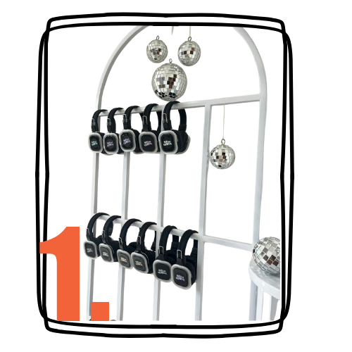 Display rack of multiple wireless headphones, decorative disco balls, and a small table with a larger disco ball.