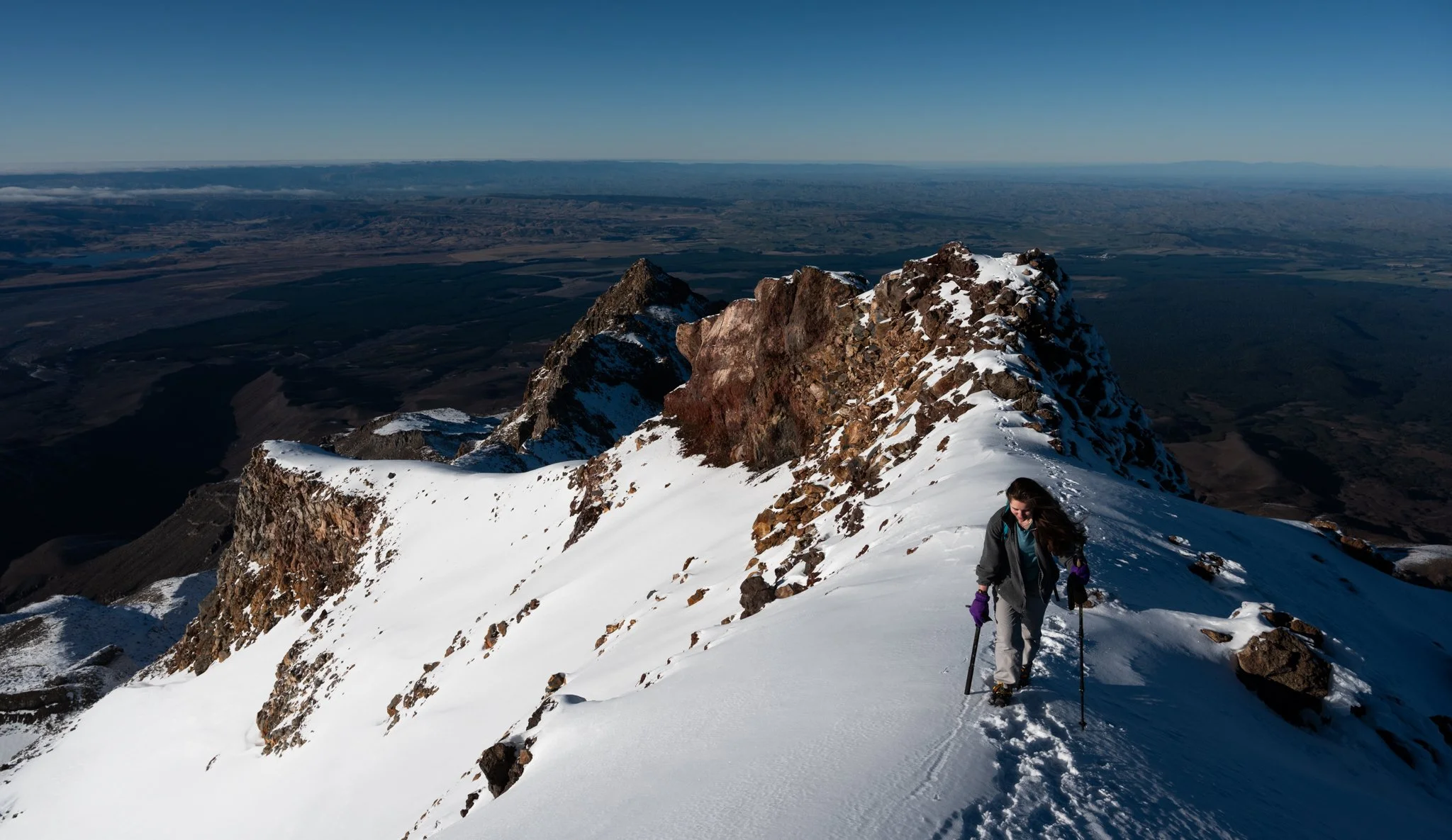 Sandra, using winter gear for the first time, near Tahurangi, with 2797m the tallest of the eleven peaks of Mount Ruapehu