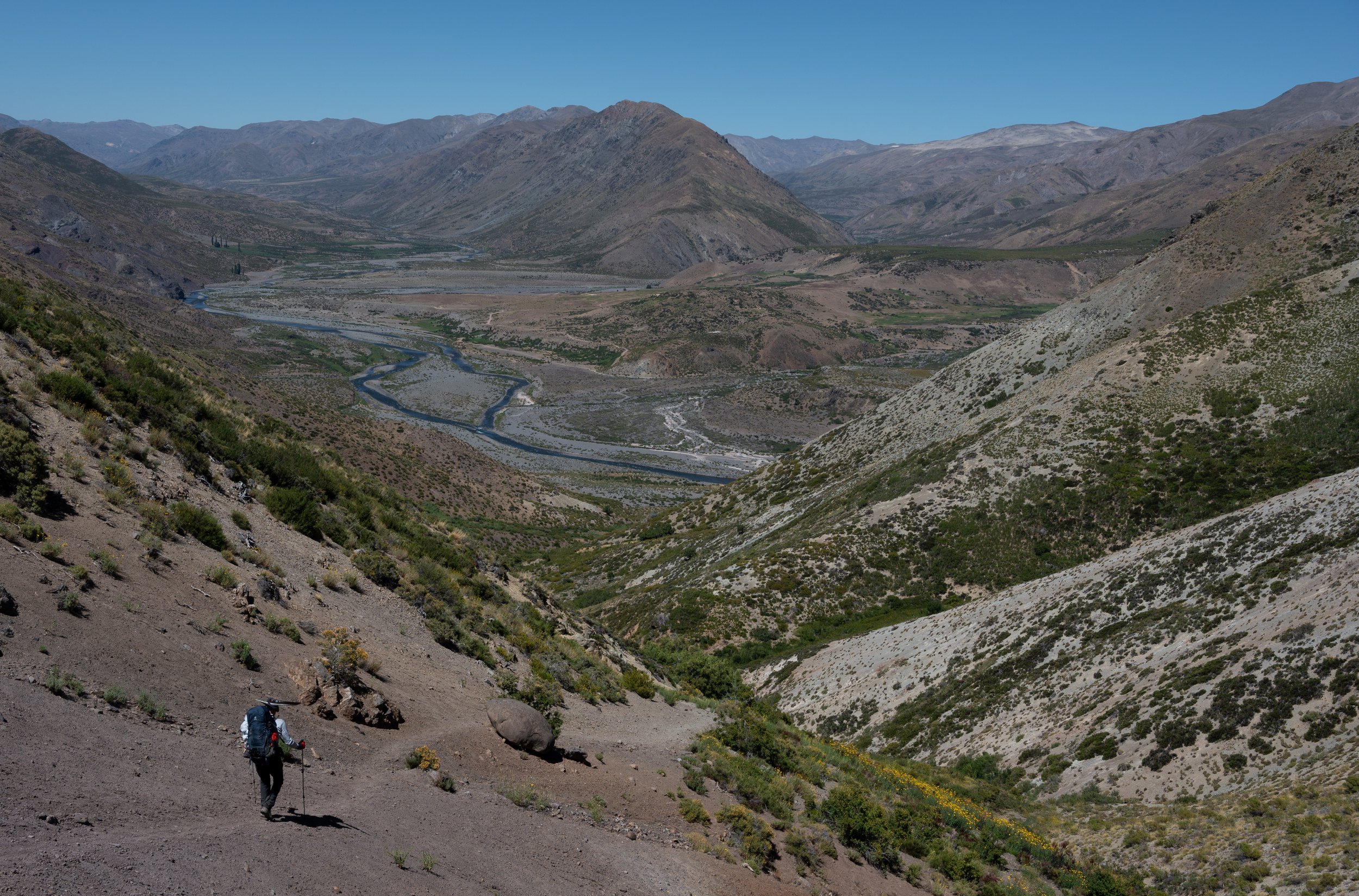We’re entering one of the endless valleys we've been trekking through. You might notice the condor feather on my father’s hat—it has become his trekking totem.