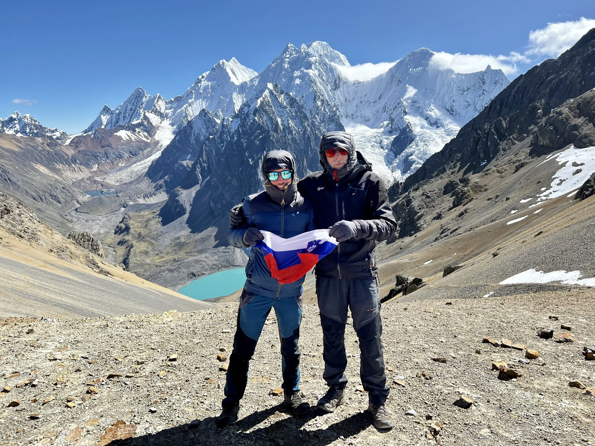 Two Slovenians proudly promoting their country atop Paso Santa Rosa. Reaching the higher passes of the circuit was always a poignant moment—each ascent revealed new, awe-inspiring views, and fellow hikers, united by the challenge, celebrated their su