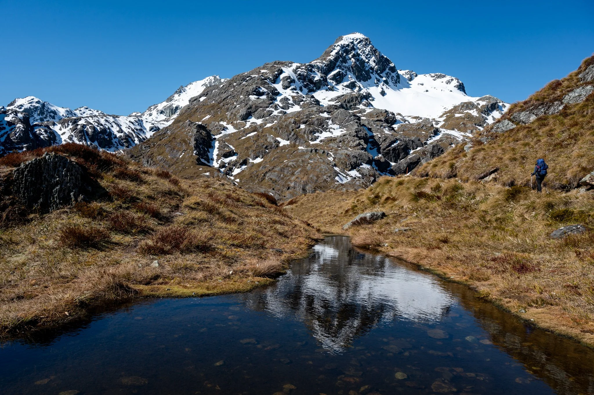 Walking towards Lake Harris on the Routeburn Track, a gateway from Fiordland into Mount Aspiring National Park.
