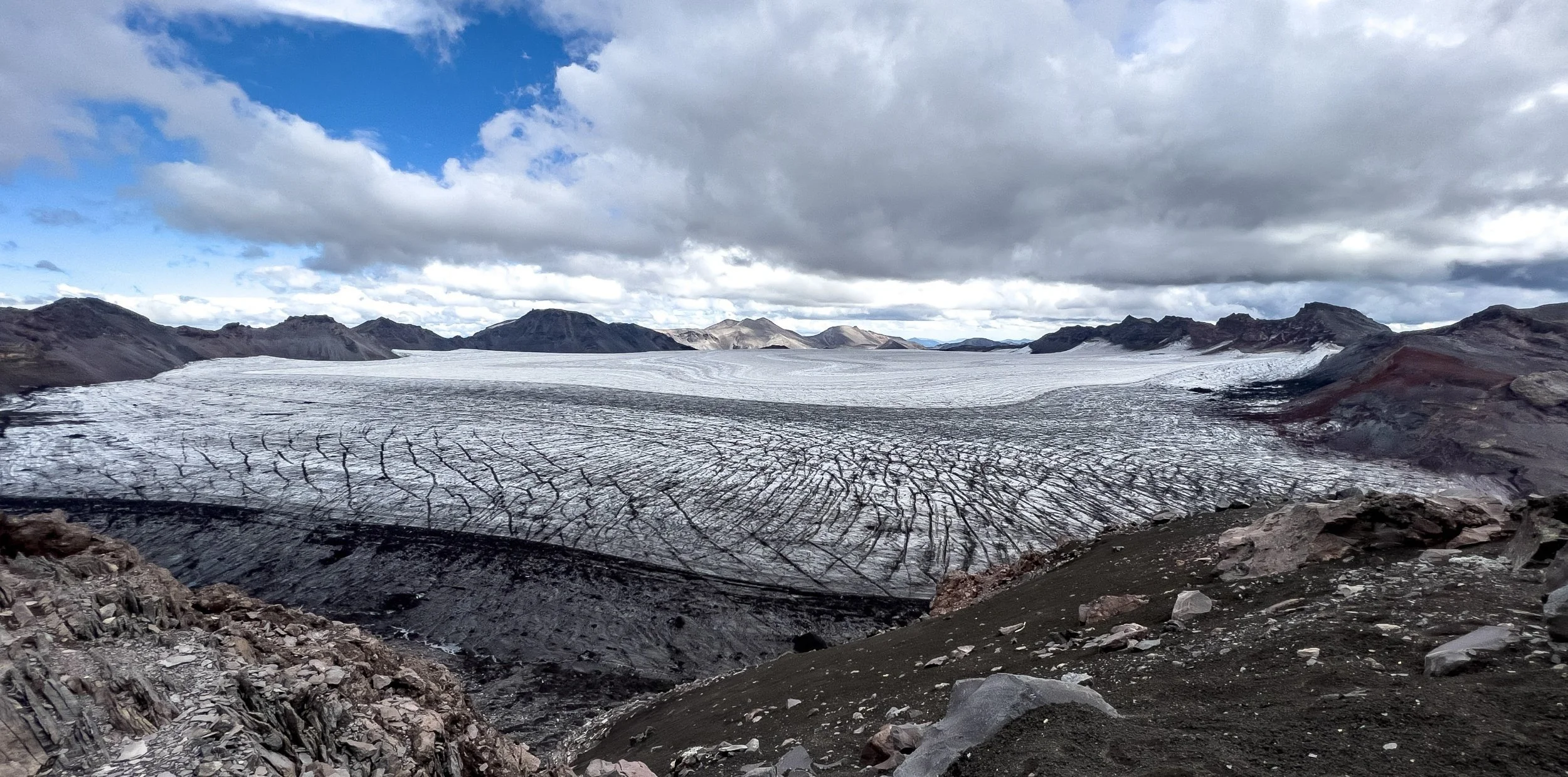 Gusts of wind reaching up to 100 km/h buffeted us on top of Sollipulli, a stratovolcano with an immense 4 km-wide caldera filled with glacial ice, up to 650 meters deep. Unlike most calderas, this one did not collapse due to an explosion; the true re