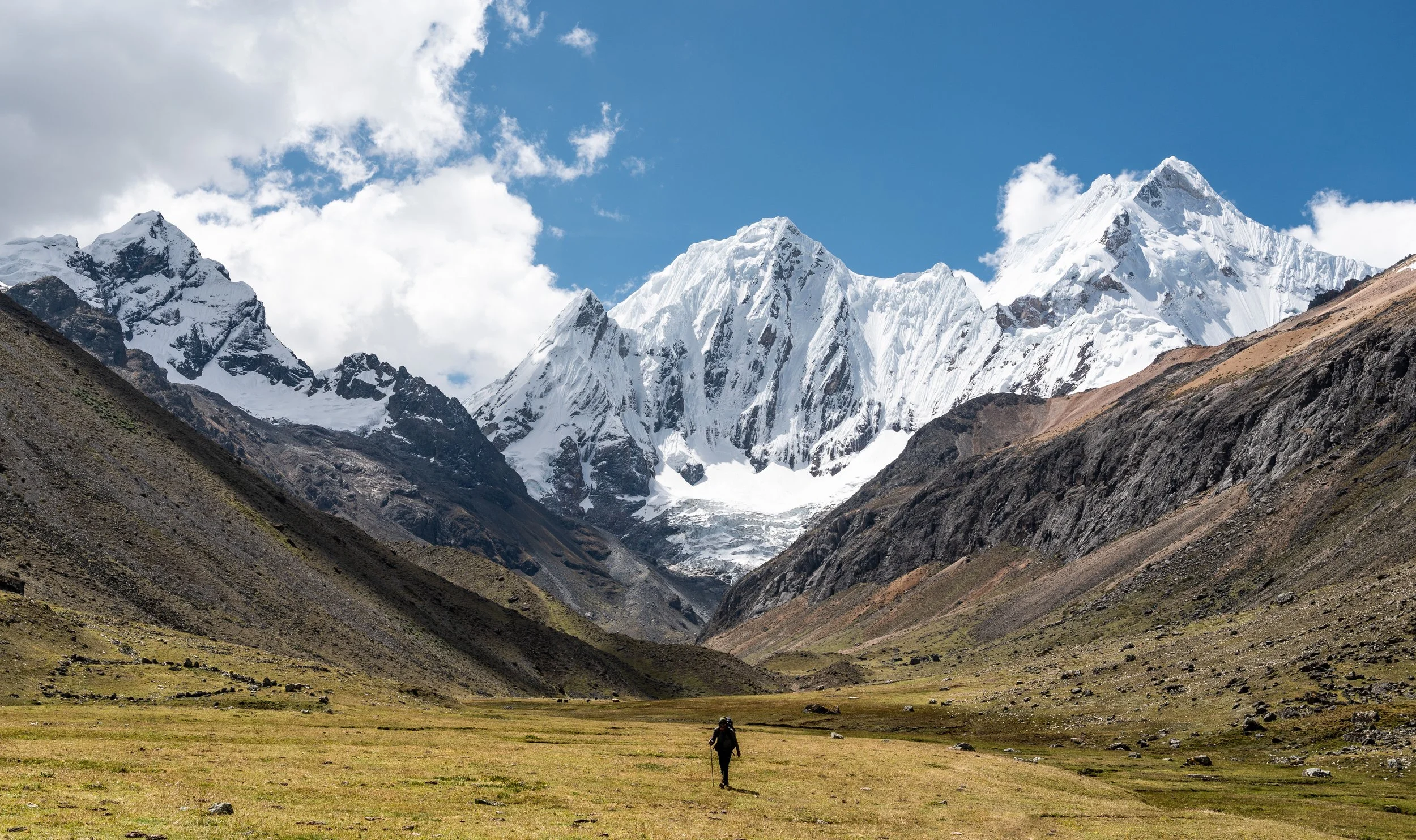Marco, a new Italian friend who joined us for much of the trek, is seen descending through the scenic Caramarca Valley, with the towering peak of Rasac (6,017 m.a.s.l.) dominating the landscape. We reached this beautiful valley from Paso Rosario, nav