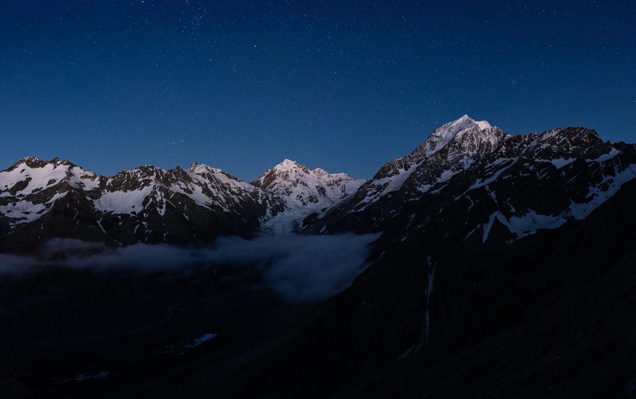 Aoraki/Mount Cook and the surrounding mountains illuminated by the moon, as seen from our camp on the way to Ball Pass.