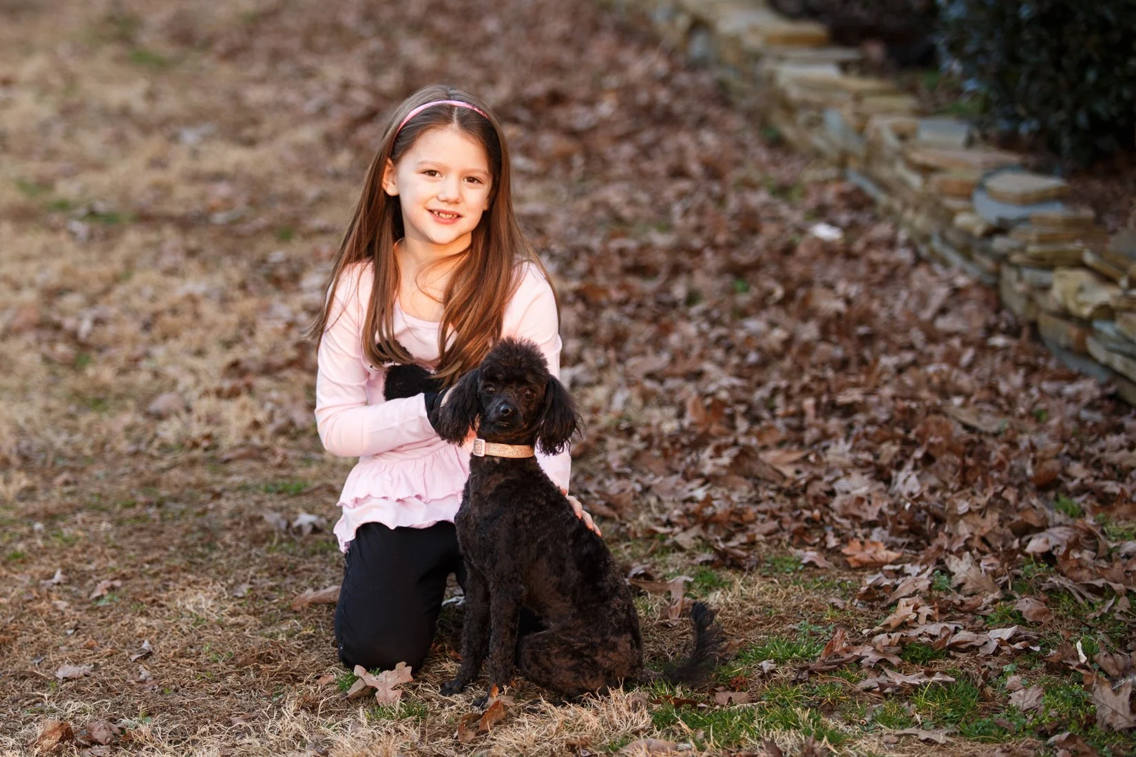 young girl with a small trained adult dog