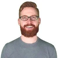 Man with glasses and red beard smiling