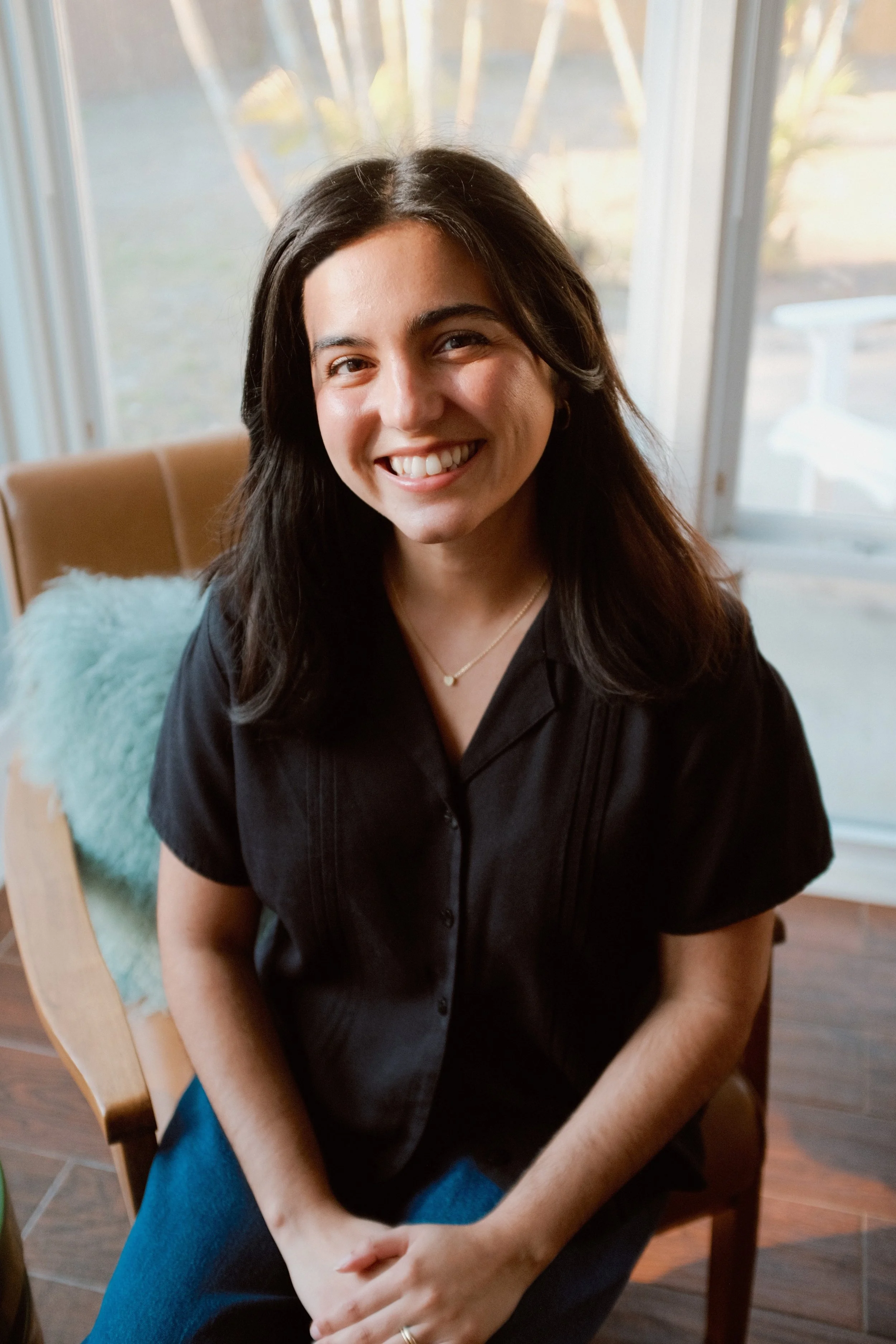 Sophie Kent LMHC Anxiety Specialist Sitting in a cozy office chair in Downtown St. Petersburg Florida