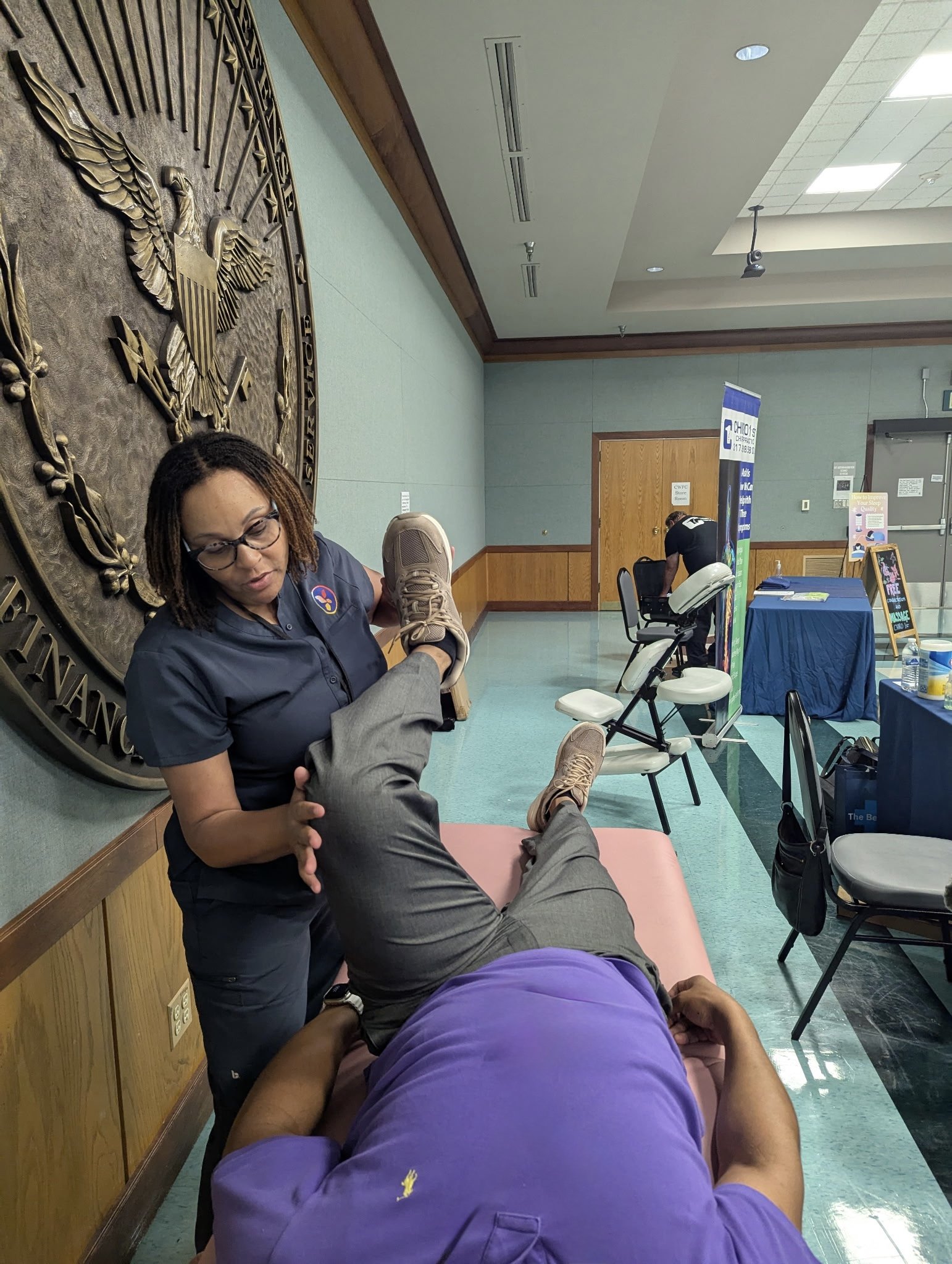 Assisted stretch therapy at a corporate wellness event — bringing movement, recovery, and body awareness into the workplace.