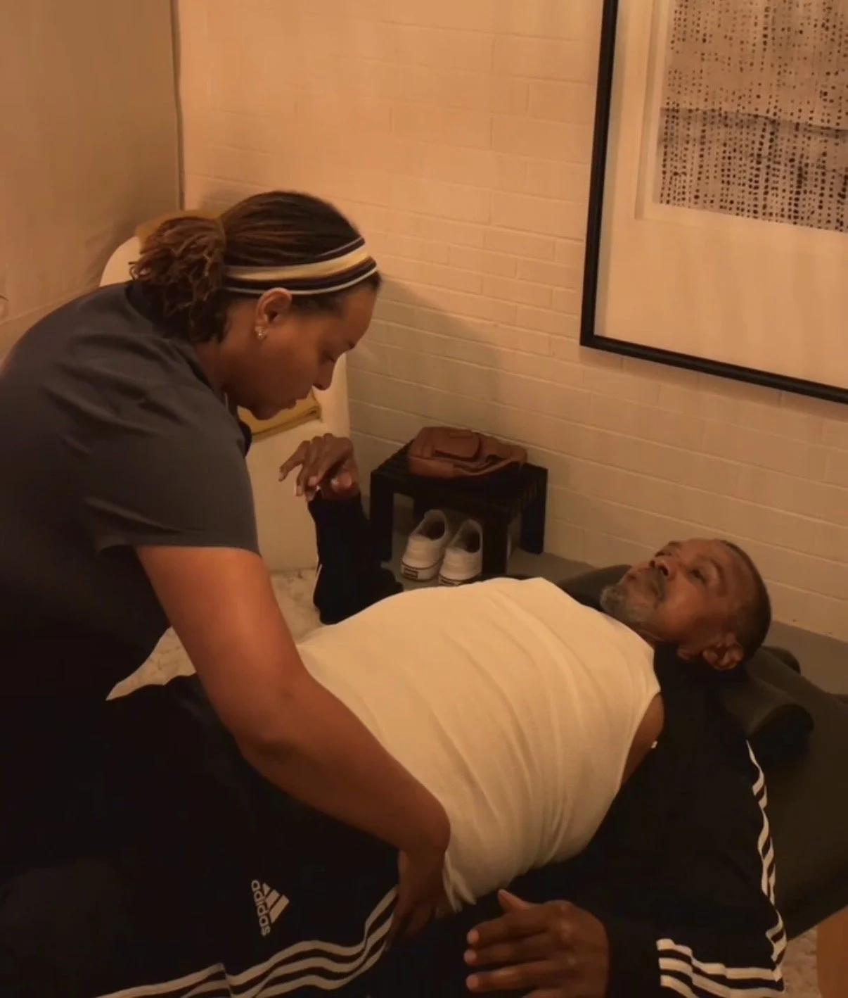 Assisted stretch therapy with an older adult — supporting mobility, comfort, and body awareness through gentle, intentional movement.