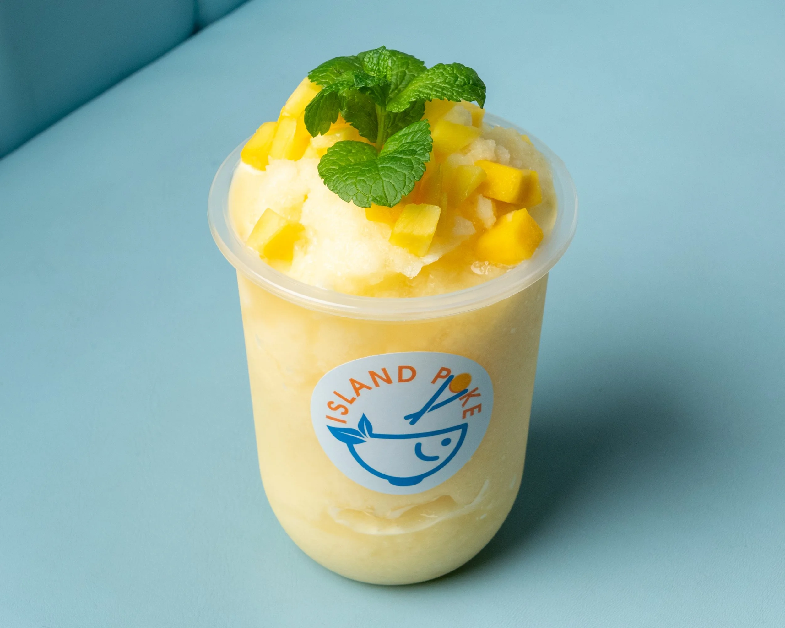 Island Poke mango smoothie made with fresh mango and ice, topped with mango cubes and mint, served in Milford, CT.