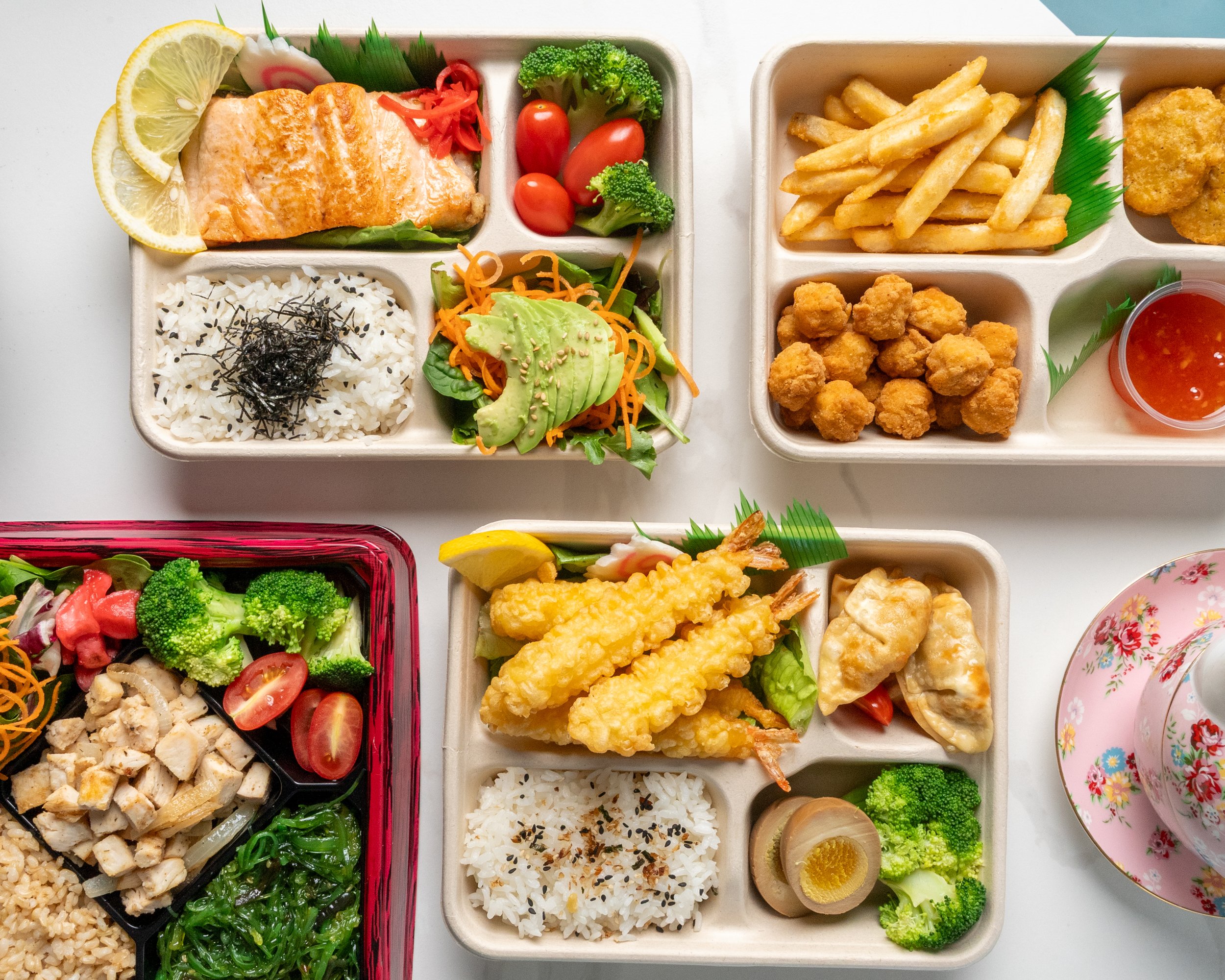 Island Poke bento lunch series with grilled salmon, shrimp tempura, crispy chicken, beef bulgogi, mapo tofu, teriyaki chicken, dumplings, rice, vegetables, and sides, offering a balanced and diverse lunch option in Milford, CT.