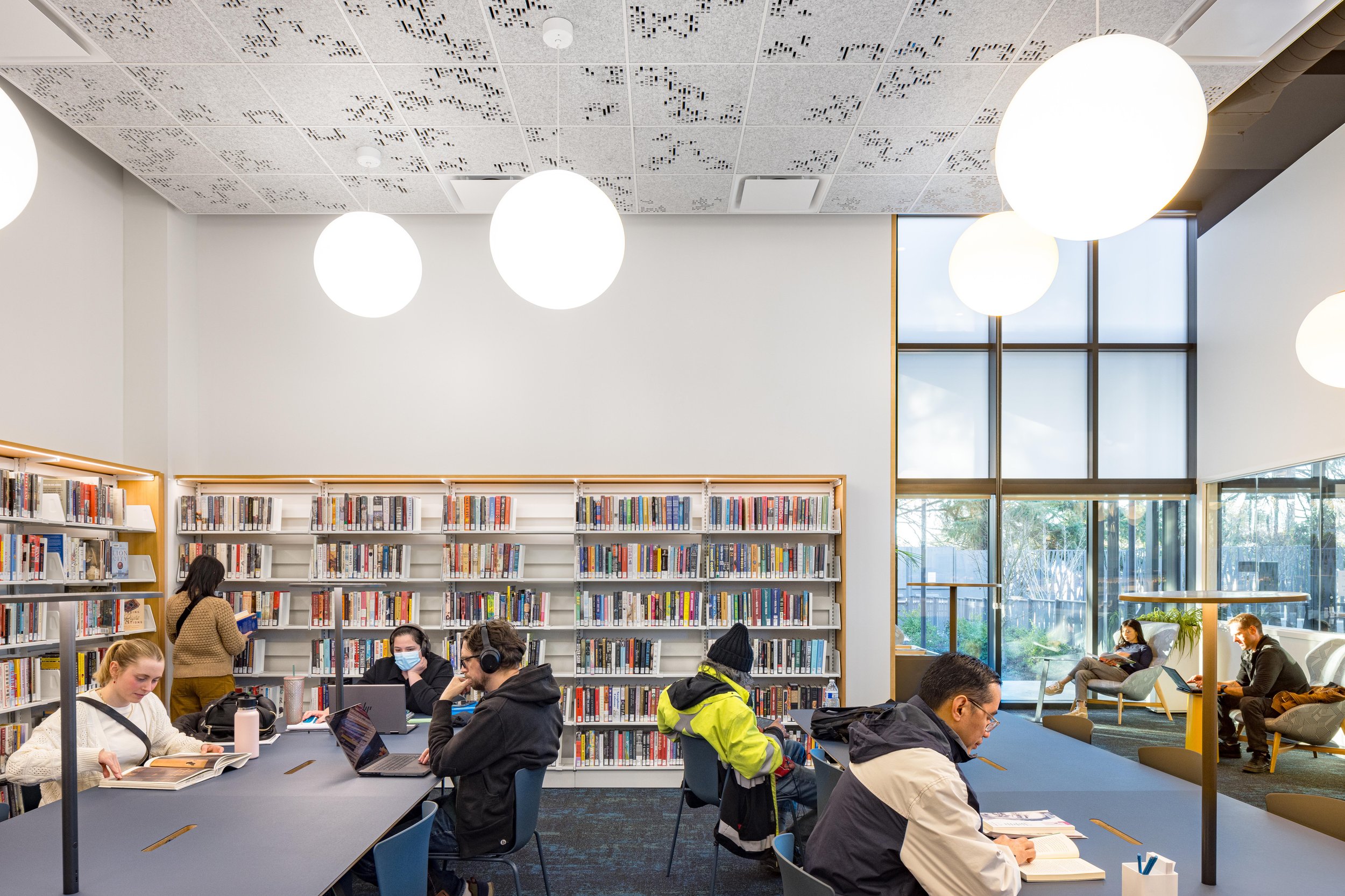 A dedicated quiet reading room provides patrons a more traditionally silent environment to read or study, while enabling the majority of the library to match the energy of multigenerational visitors, including children and their caregivers.
