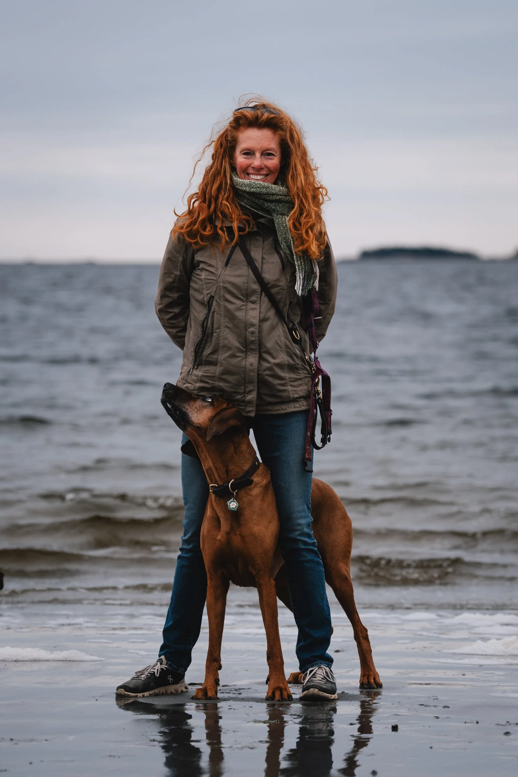 Woman with her Rhodesian Ridgeback during a pet photography session in Owls Head, Maine