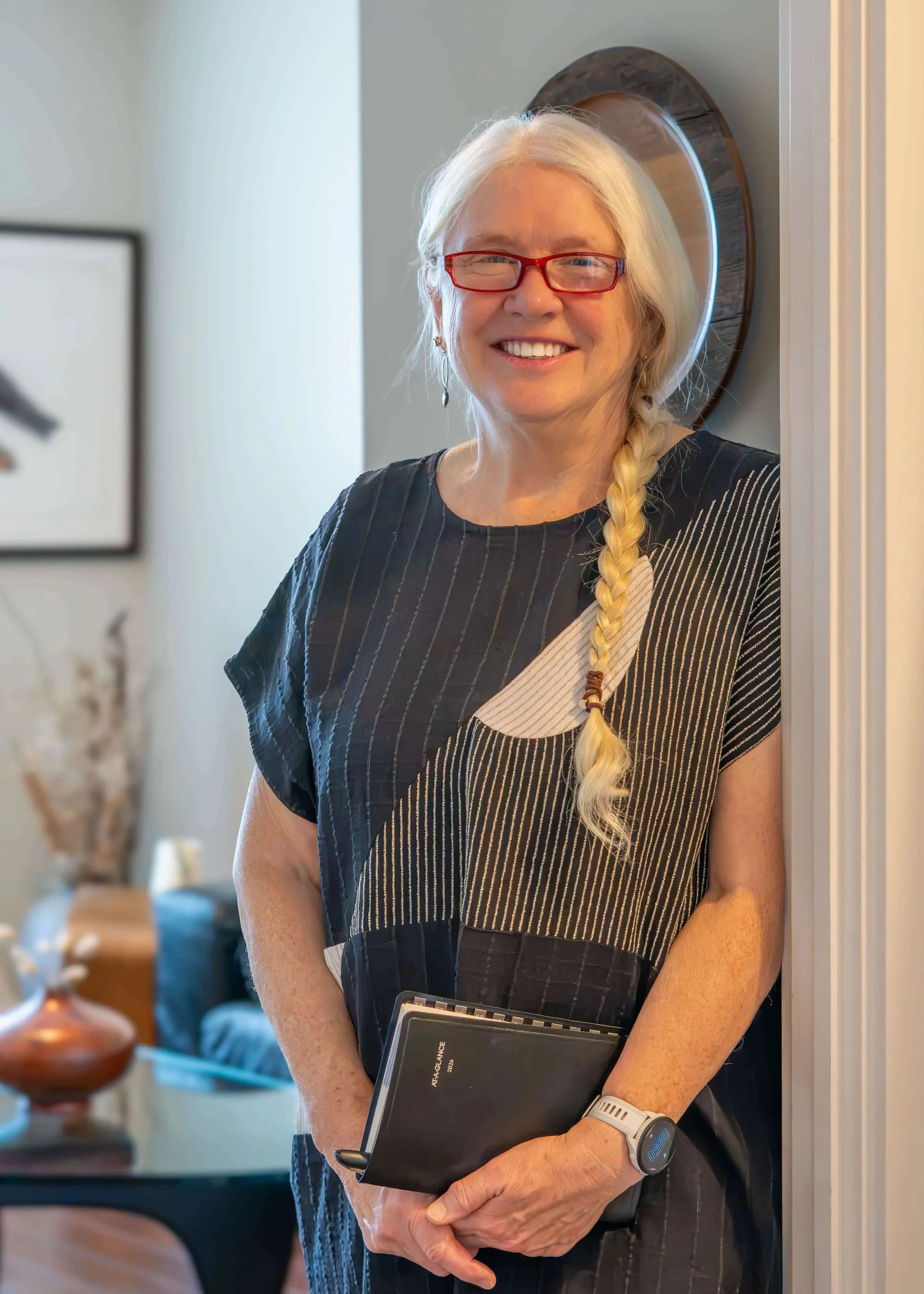 Dianne Hayman MSW RSW standing in the doorway of her counselling office where she provides online  individual and couples therapy to residents of Ontario.
