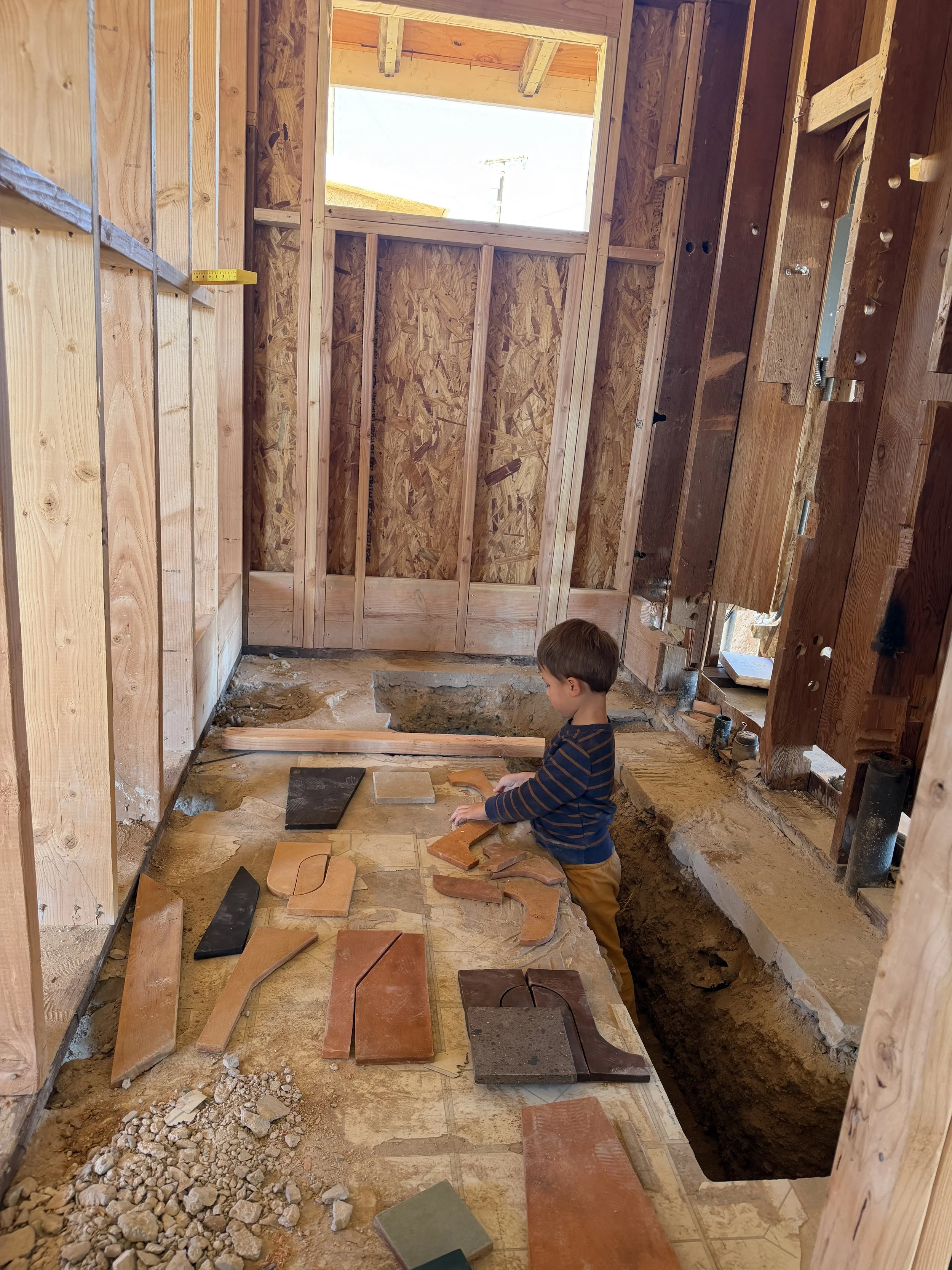 My son playing with his “puzzle pieces” - arranging Zia Tile samples on the subfloor of the guest bathroom under construction at ‘The Blue Parrot’ in Joshua Tree, California.