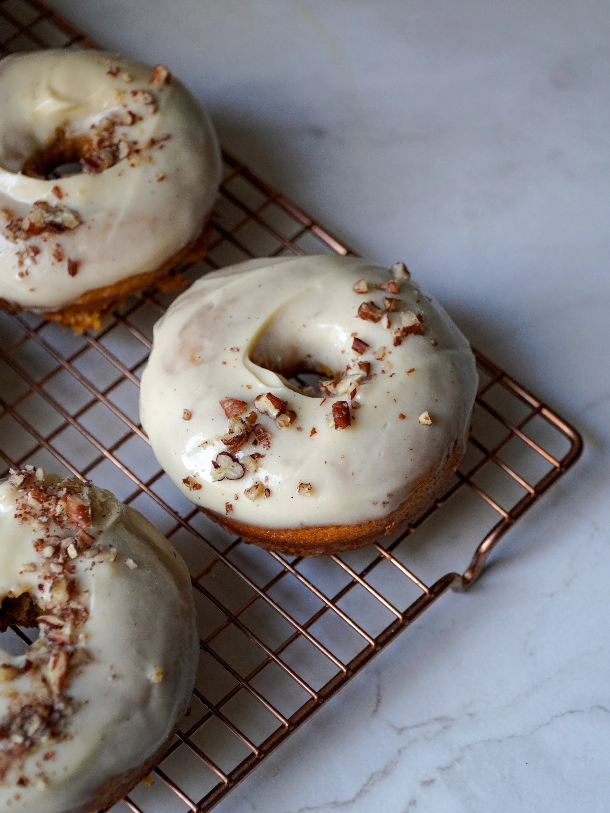 Baked Pumpkin Spice Donuts with Maple Cream Cheese Glaze
