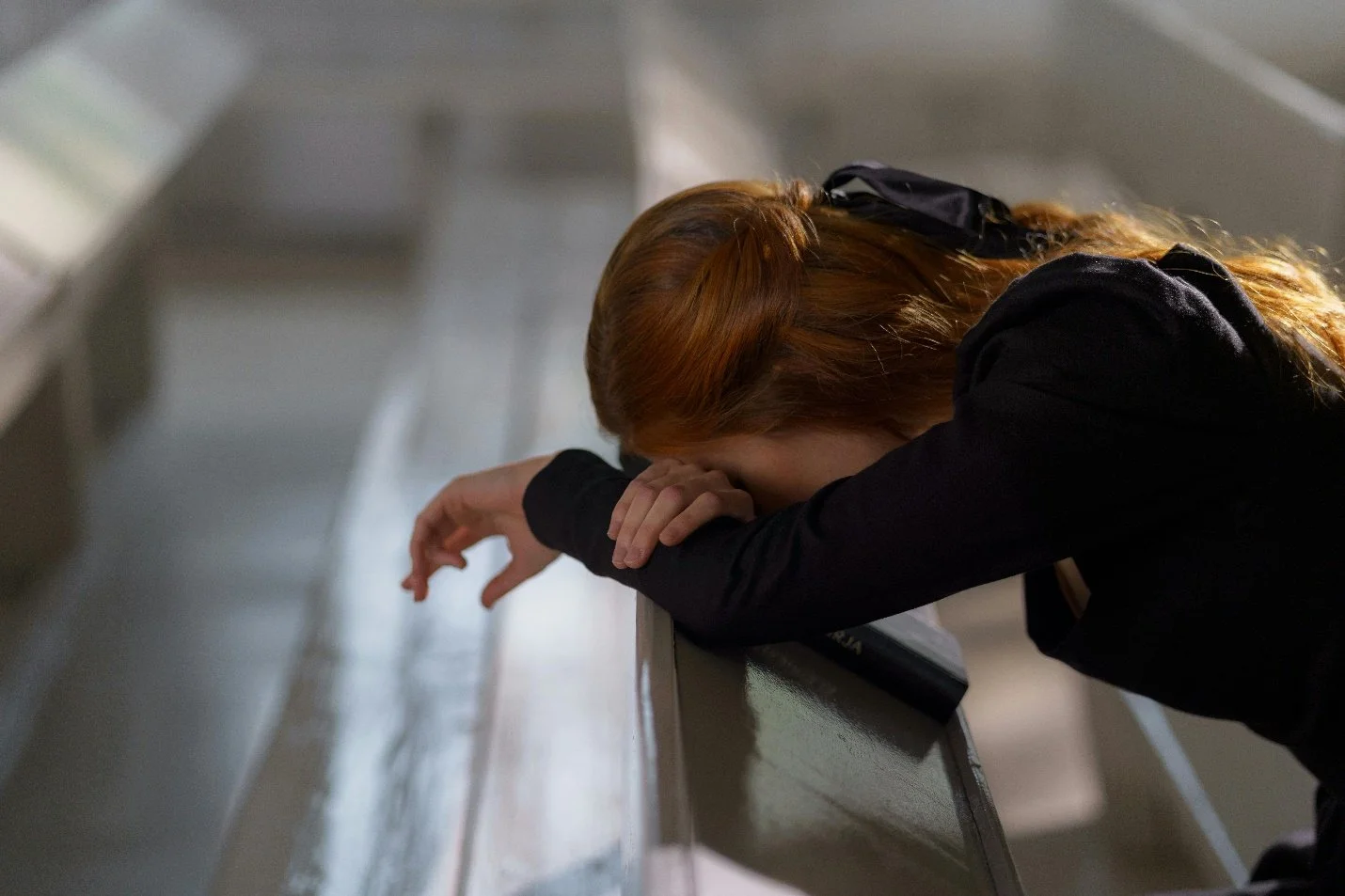 A woman bent down and praying