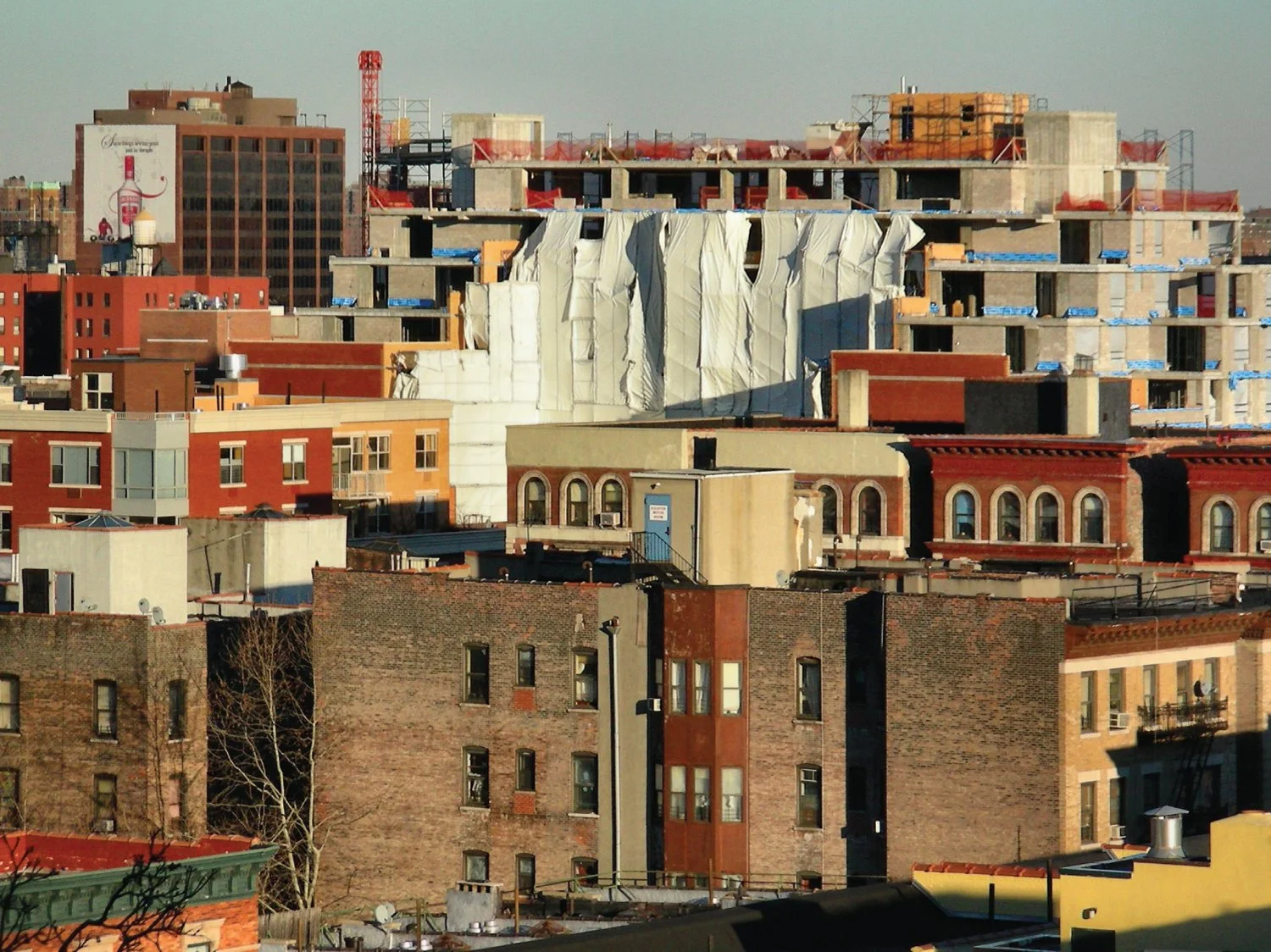  A cityscape image showing a mix of buildings, some under construction, symbolizing urban development. 