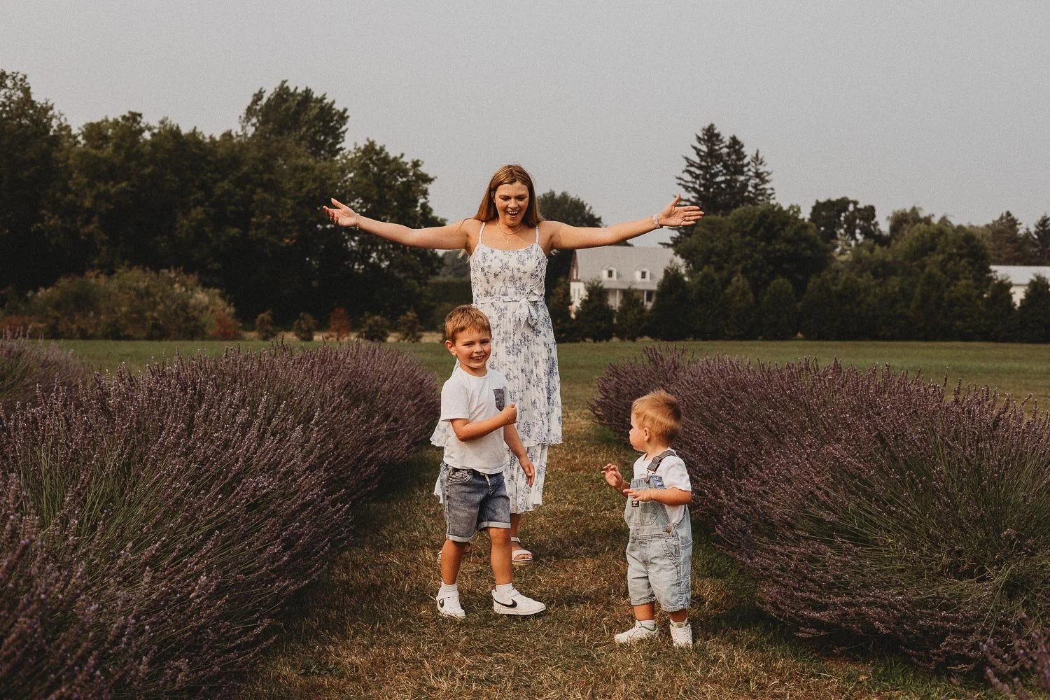 Mom and boys dancing at la Maison Lavande, St-Eustache during an outdoor family photo session