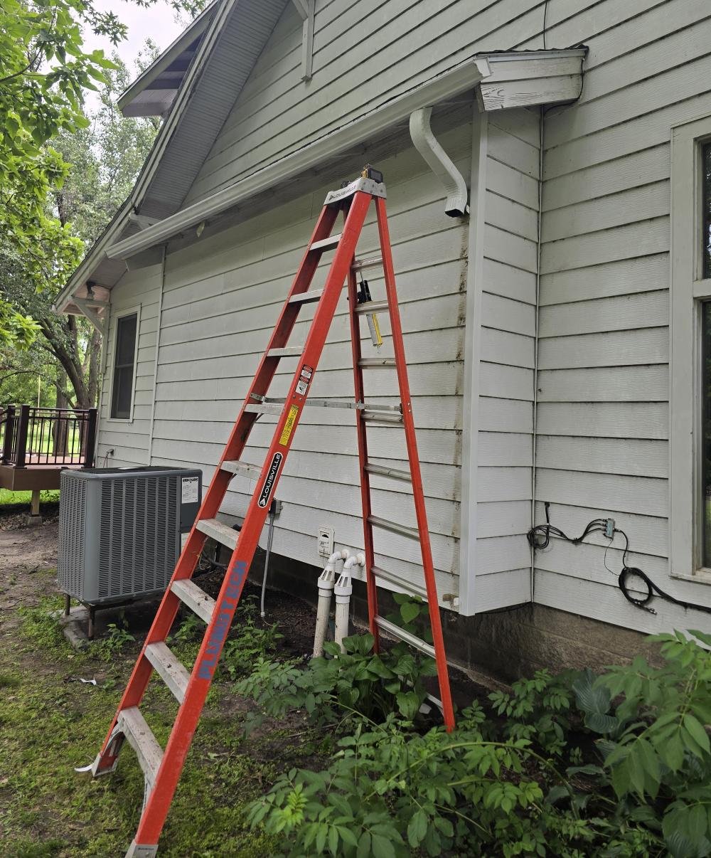 Image of new gutter install with new downspout installation in process