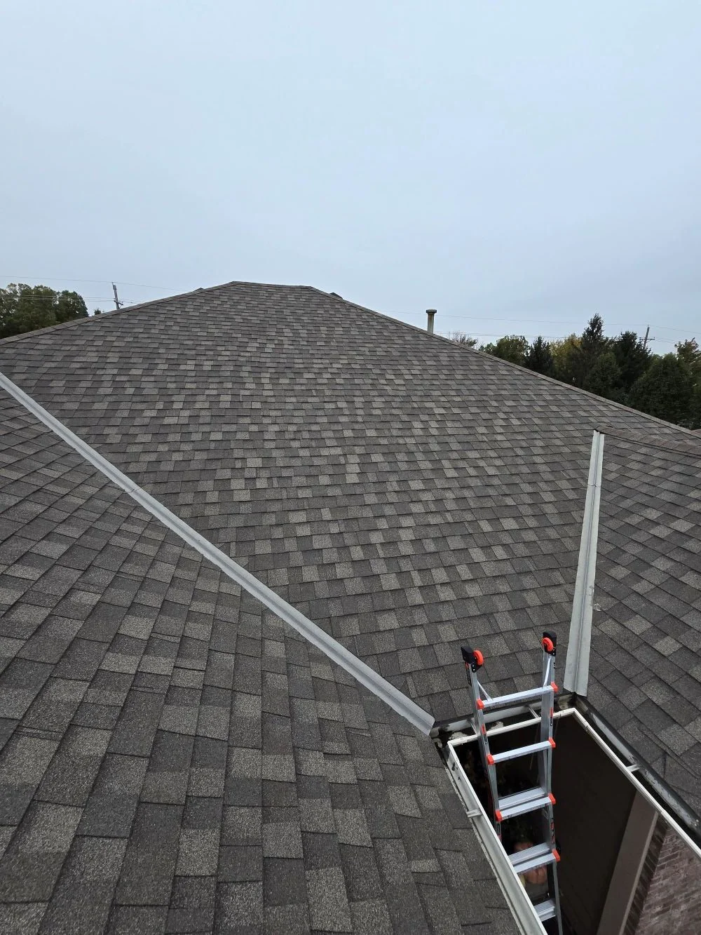 roof valley where two slopes meet showing common leak area on asphalt shingle roof