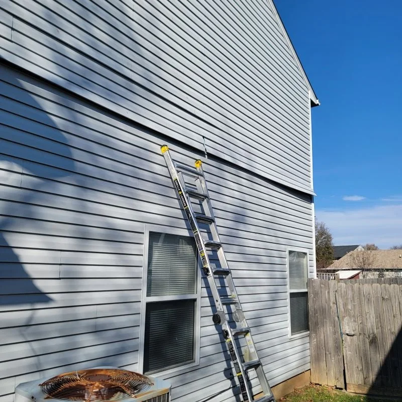 Damaged vinyl siding falling off on a home in Bellevue