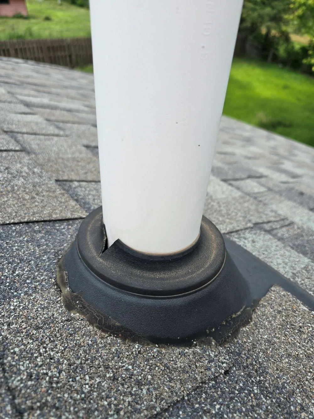 cracked pipe boot flashing around plumbing vent causing roof leak on asphalt shingle roof