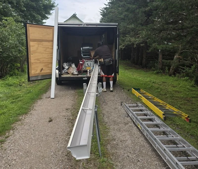 Seamless gutter machine and trailer setup highlighting the making of a custom seamless gutter to be installed at a home in Omaha.