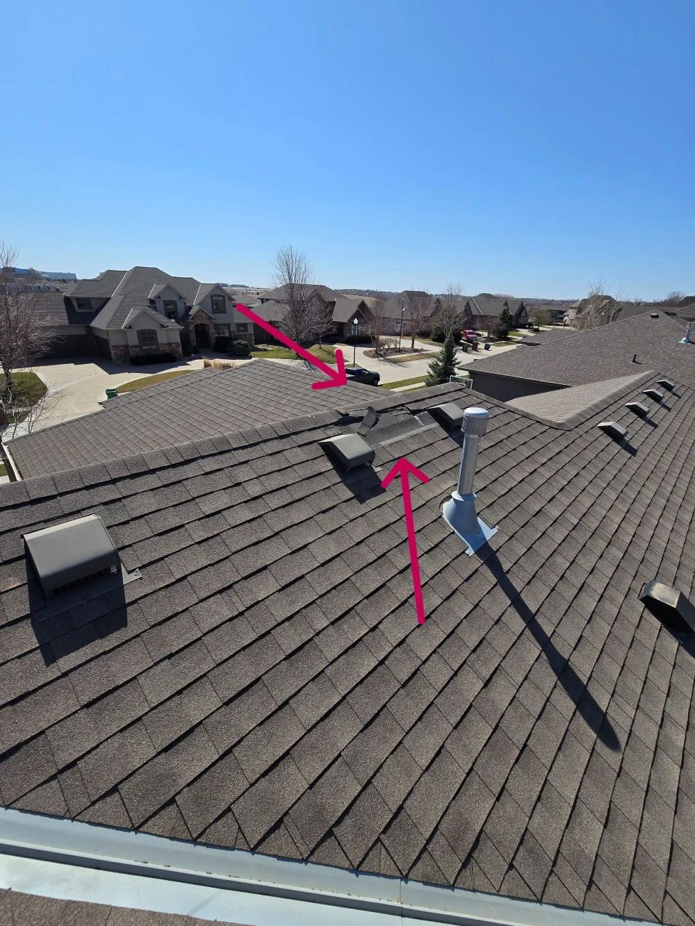 missing asphalt shingles from wind damage exposing roof underlayment