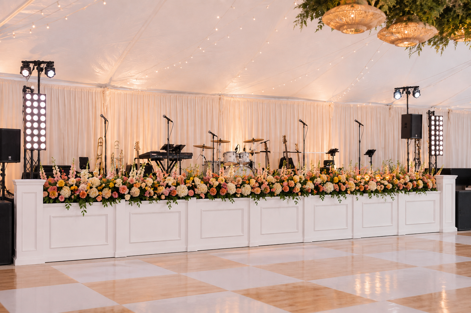 Classic white stage facade with paneled detailing and coordinating columns for wedding band and entertainment staging.