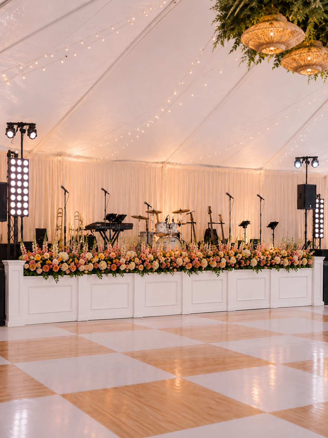 Classic white stage facade with paneled detailing and coordinating columns for wedding band and entertainment staging.