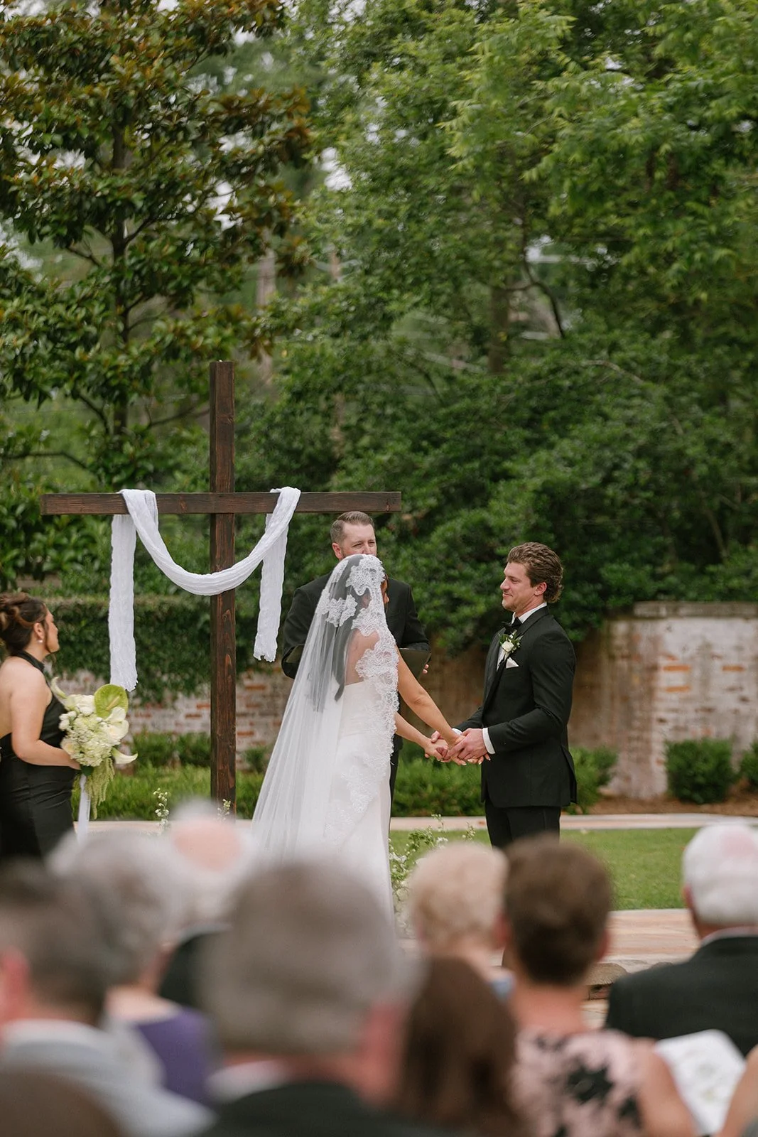 A handcrafted wooden cross stained a beautiful dark wood color available for weddings and events in Savannah, GA and beyond.