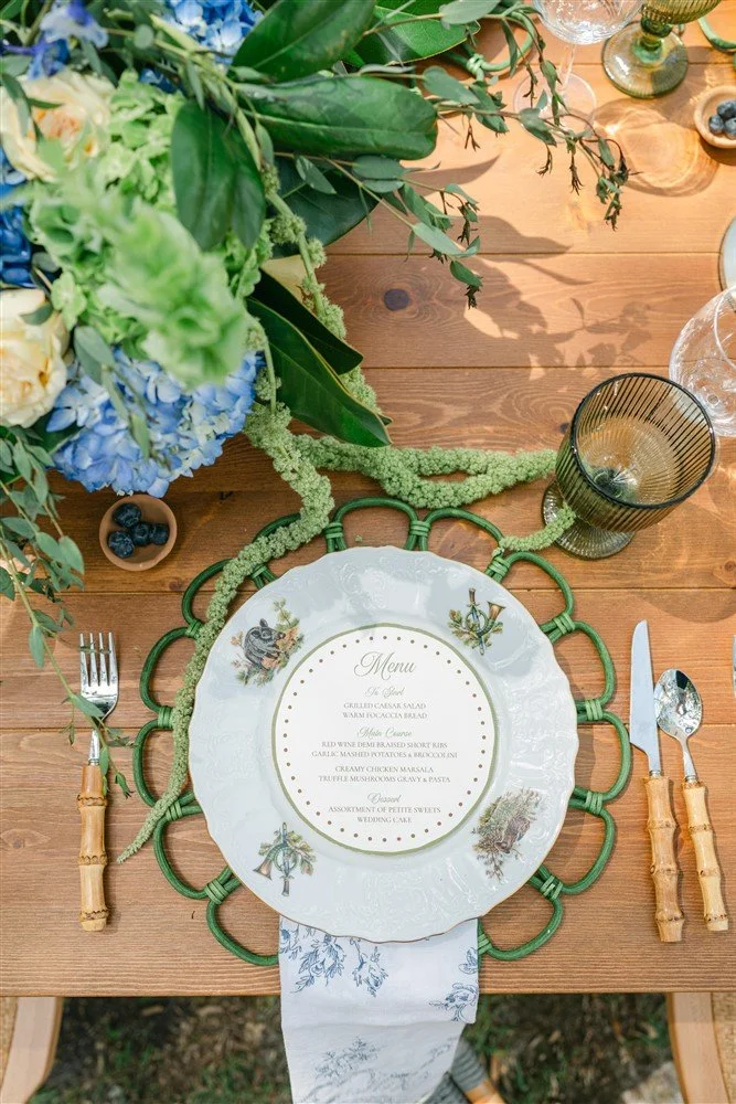 A fern green, rattan, flower-shaped charger plate available for weddings and events in Savannah, GA.