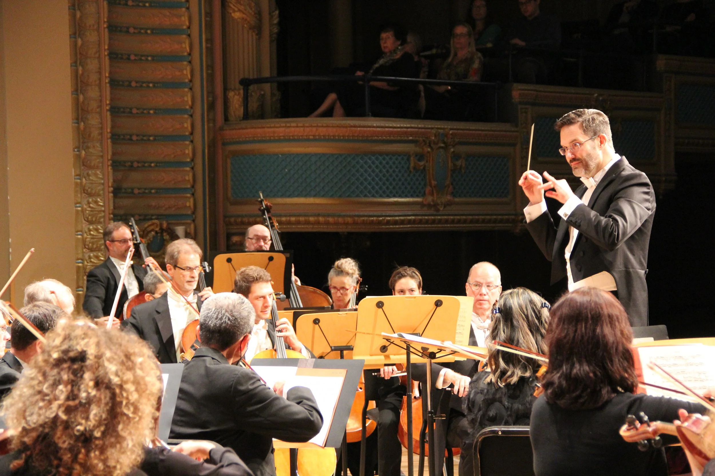 Photo of Matthew Kraemer conducting orchestra
