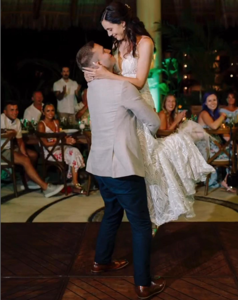 Laurie’s customers, Fernando and Kate embracing by the lake on their wedding day.