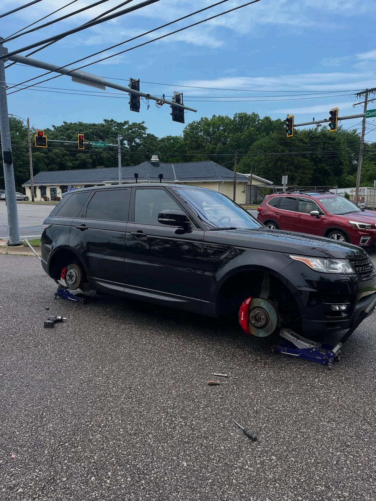Wheel Refinish and rash repair service on this Range Rover Sport, from flaking grey to perfect gloss black!