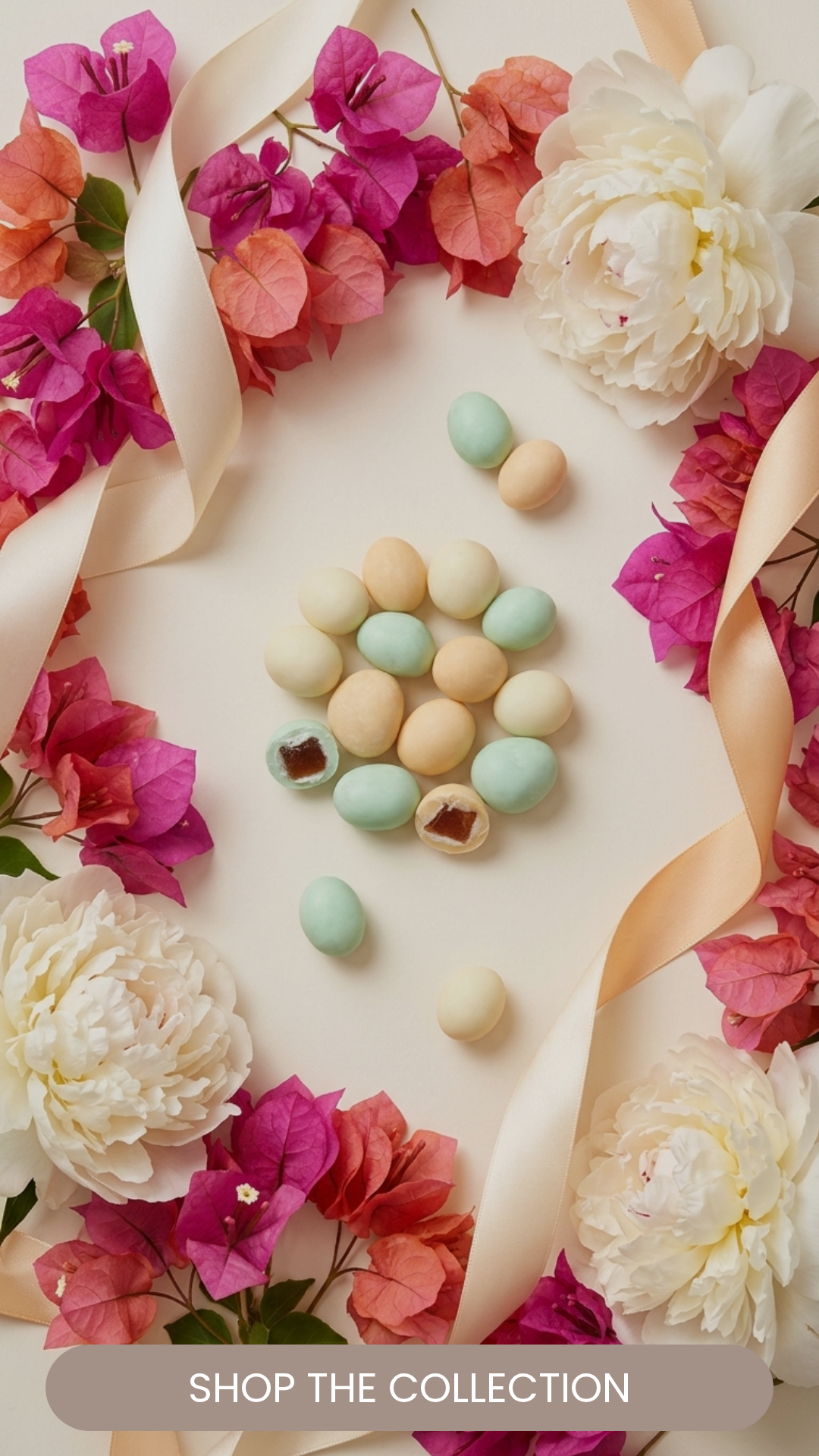 Colorful candy eggs surrounded by pink and white flowers with cream-colored ribbons.