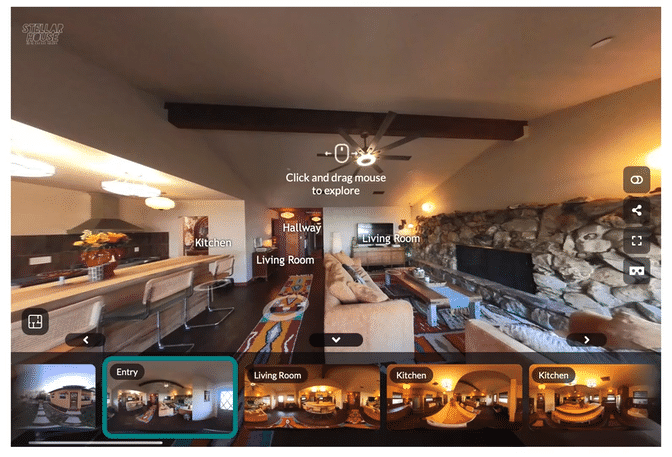 Modern kitchen with white marble countertops, gray cabinets, stainless steel appliances, and pendant lights.