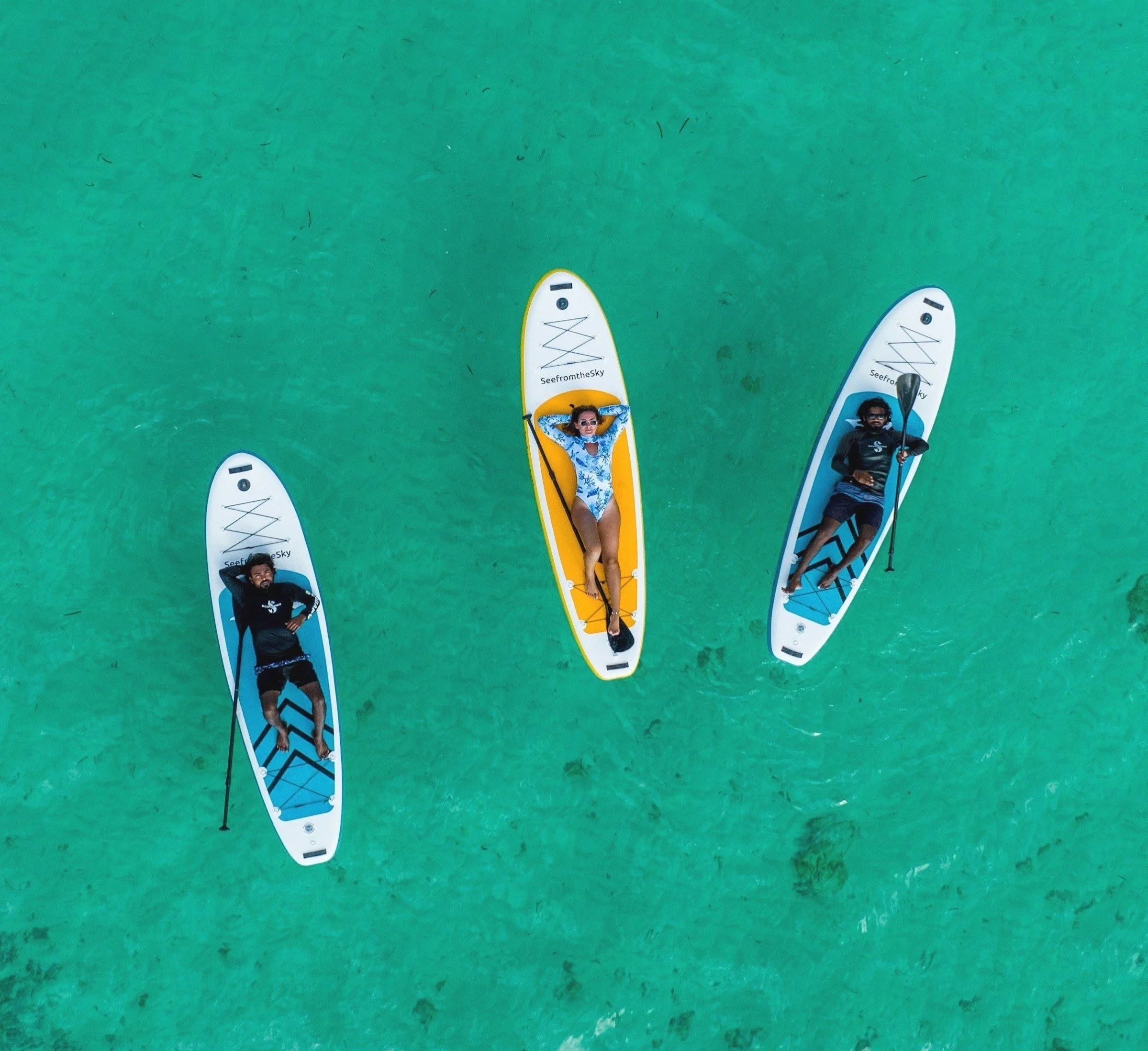 people laying on SUP boards