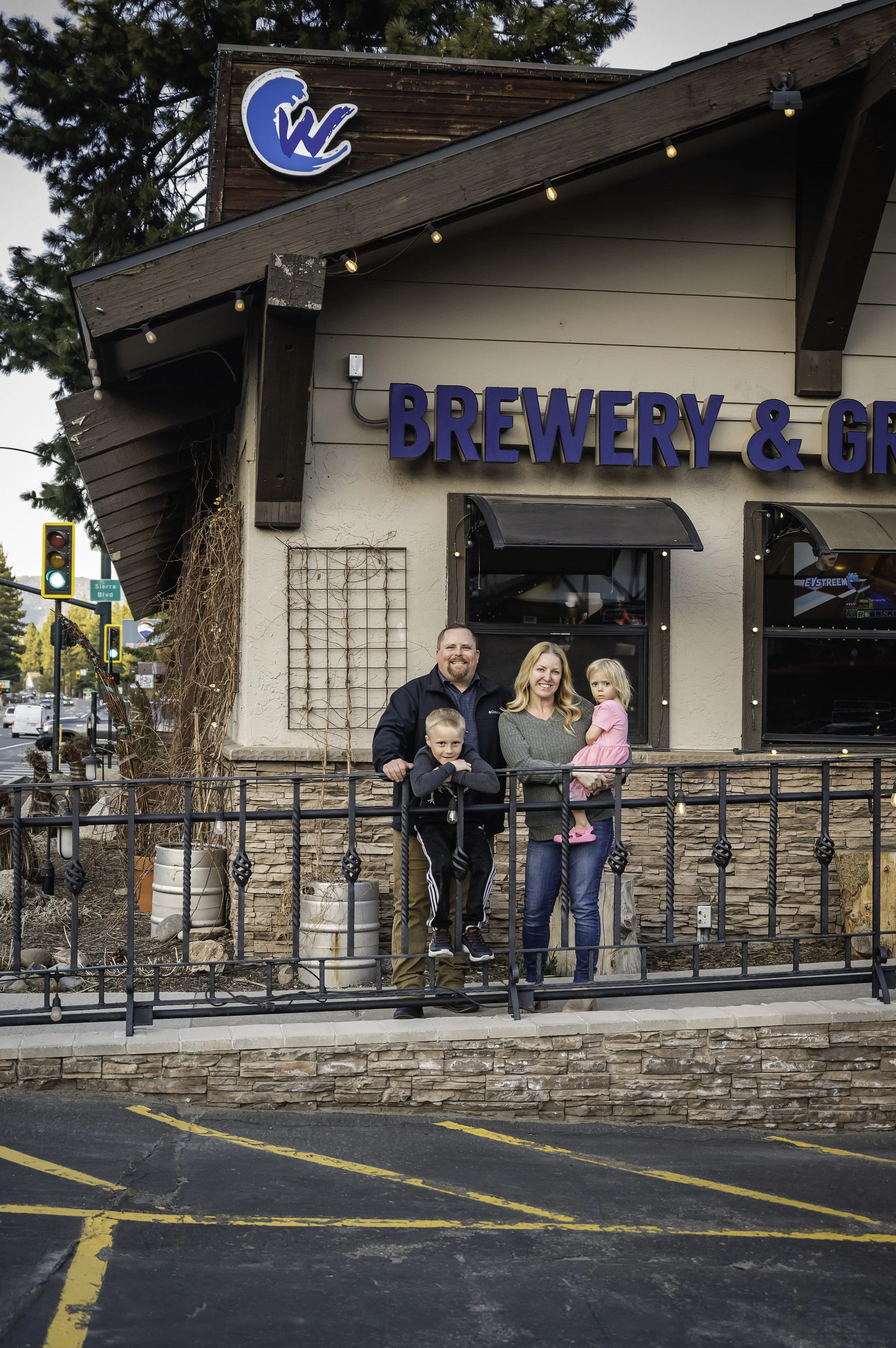 Family-owned South Lake Tahoe brewery owners standing in front of Cold Water Brewery & Grill, proud supporters of the local community and school families.