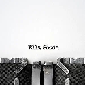 Close-up of a vintage typewriter with the name "Ella Goode" typed on a blank white sheet of paper.
