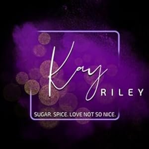 A neon sign reading 'Kay RILEY' with the tagline 'SUGAR. SPICE. LOVE NOT SO NICE.' against a dark purple background with bokeh light effects.