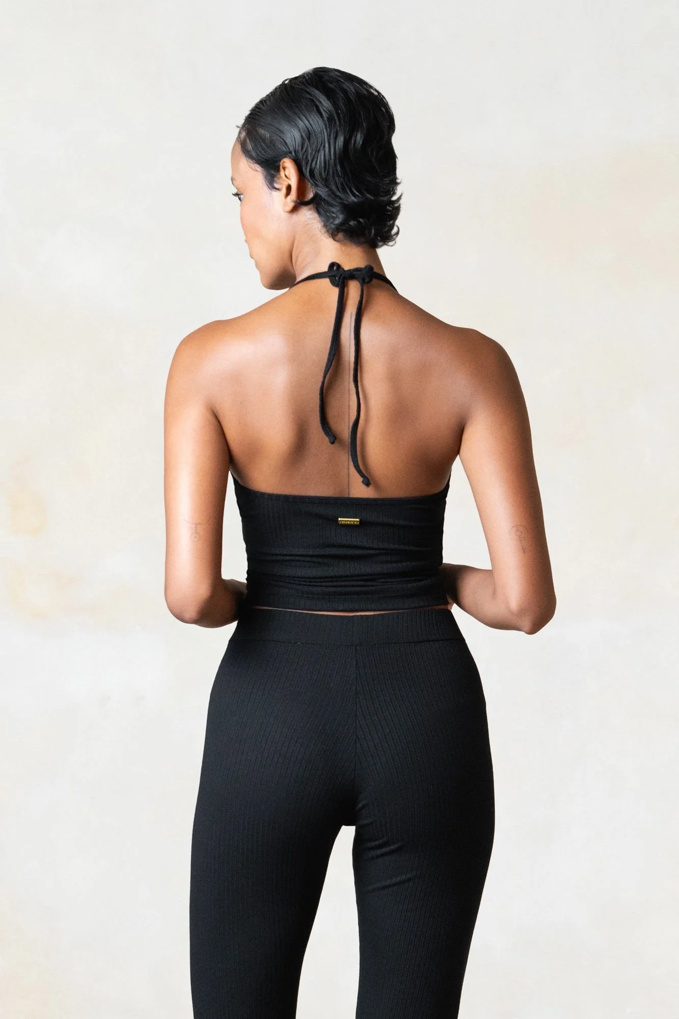 Women's ribbed ECOVERO flares in black, worn, back view