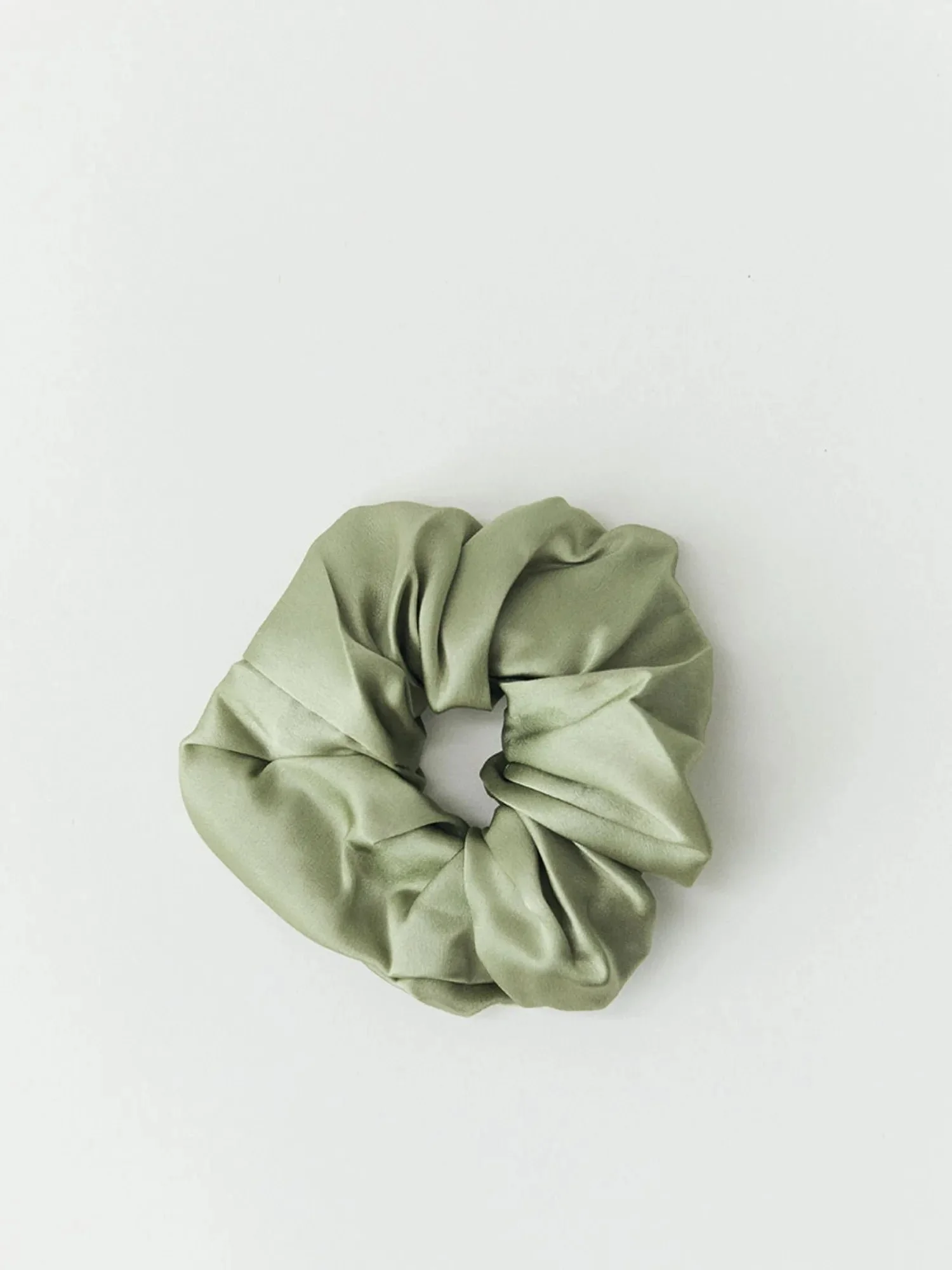Mulberry silk scrunchie in sage, on white