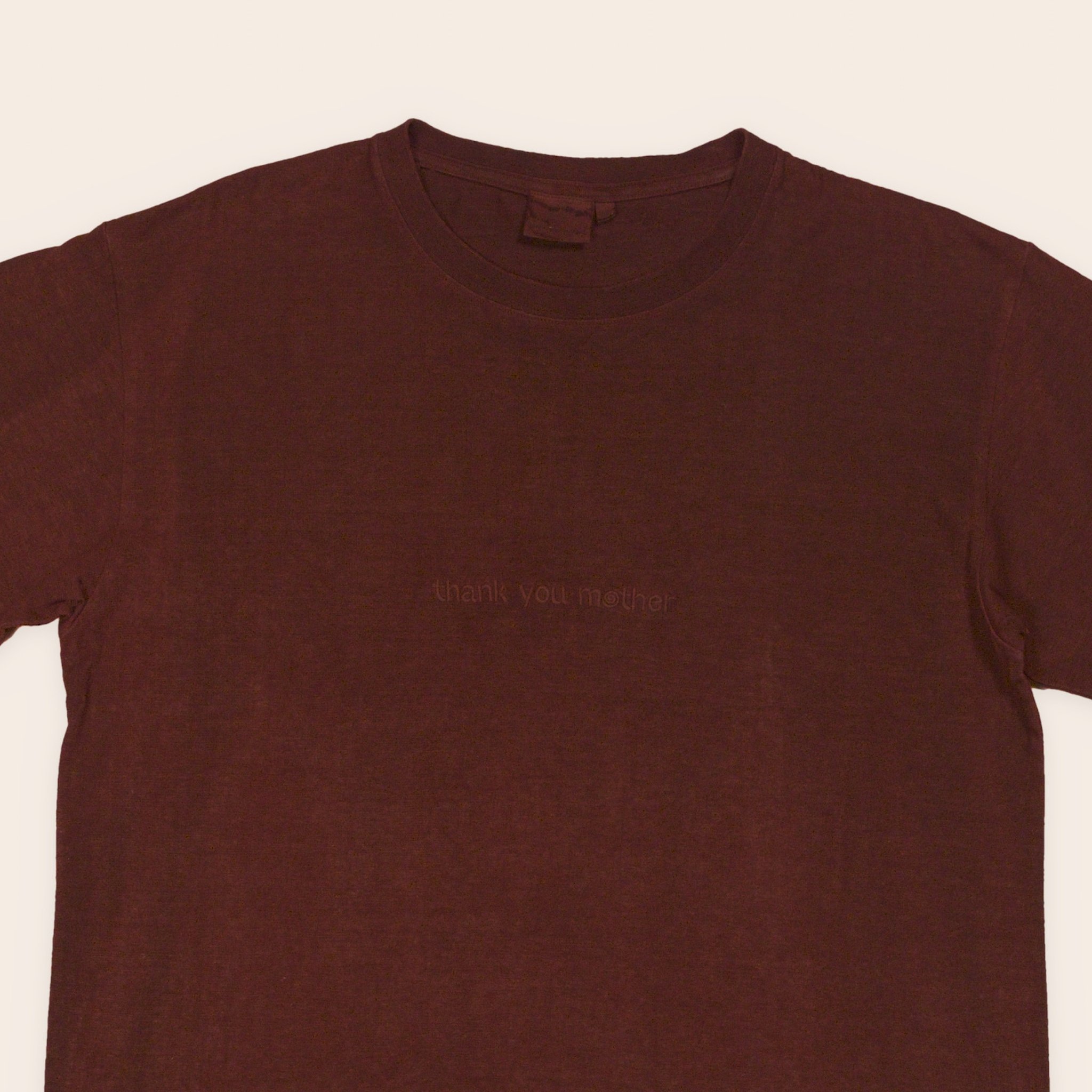 Men's plant dyed hemp tee in walnut and madder, embroidered chest close-up