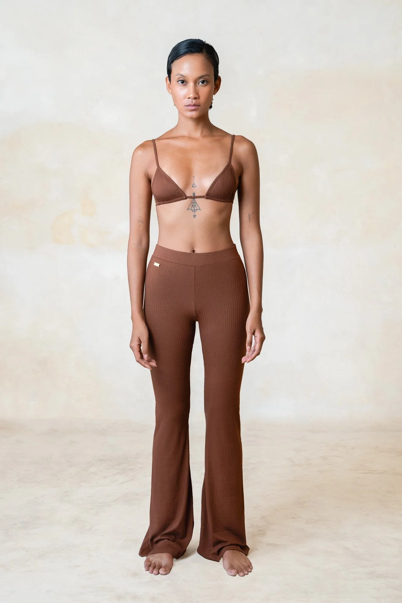 Women's ribbed ECOVERO flares in chocolate, worn with a matching bra, front view