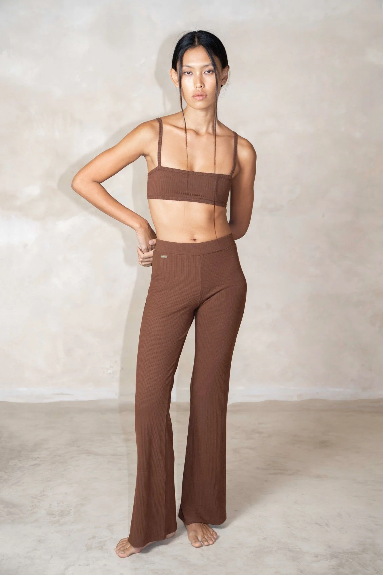 Women's ribbed ECOVERO flares in chocolate, worn with a matching crop top