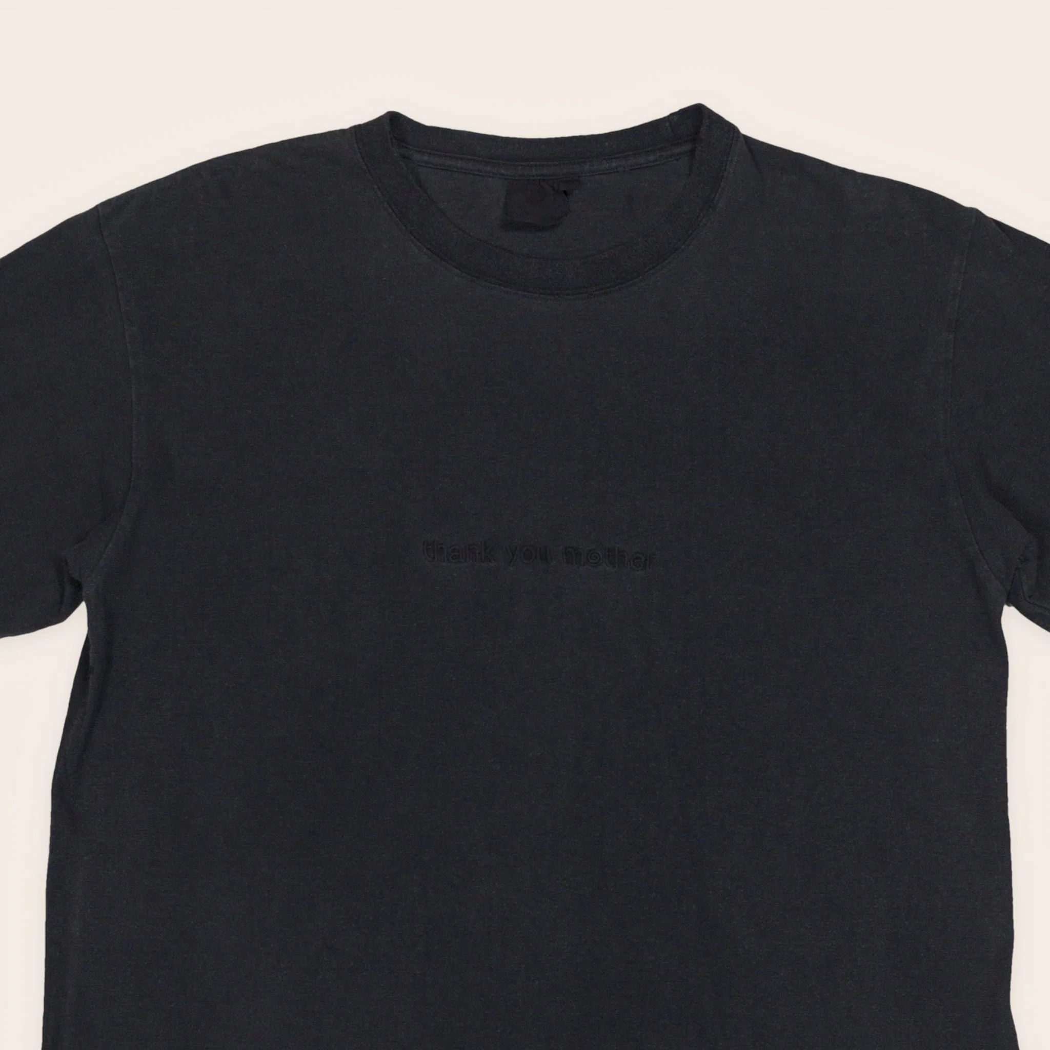 Men's plant dyed hemp tee in indigo and walnut, embroidered chest close-up