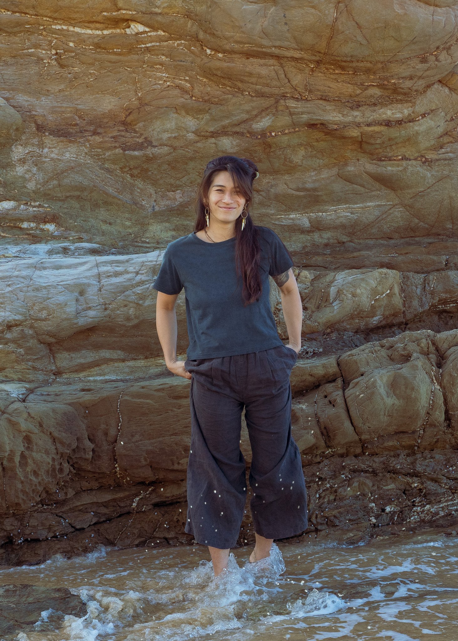 Women's cropped plant dyed hemp tee in indigo, worn on the beach